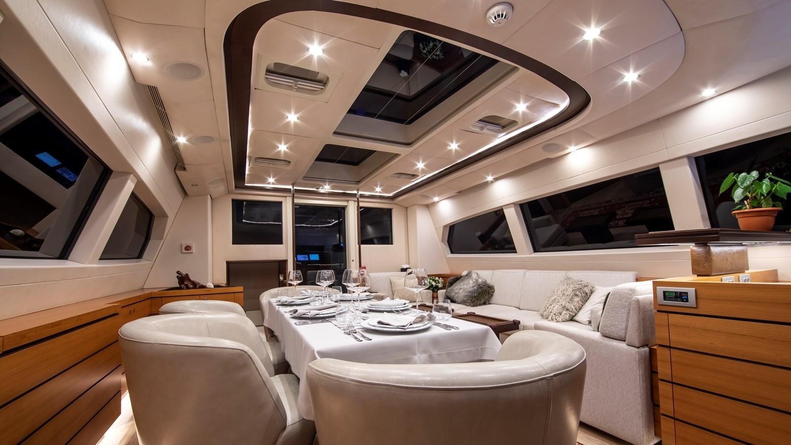 a room with a table and chairs aboard PATEA Yacht for Sale