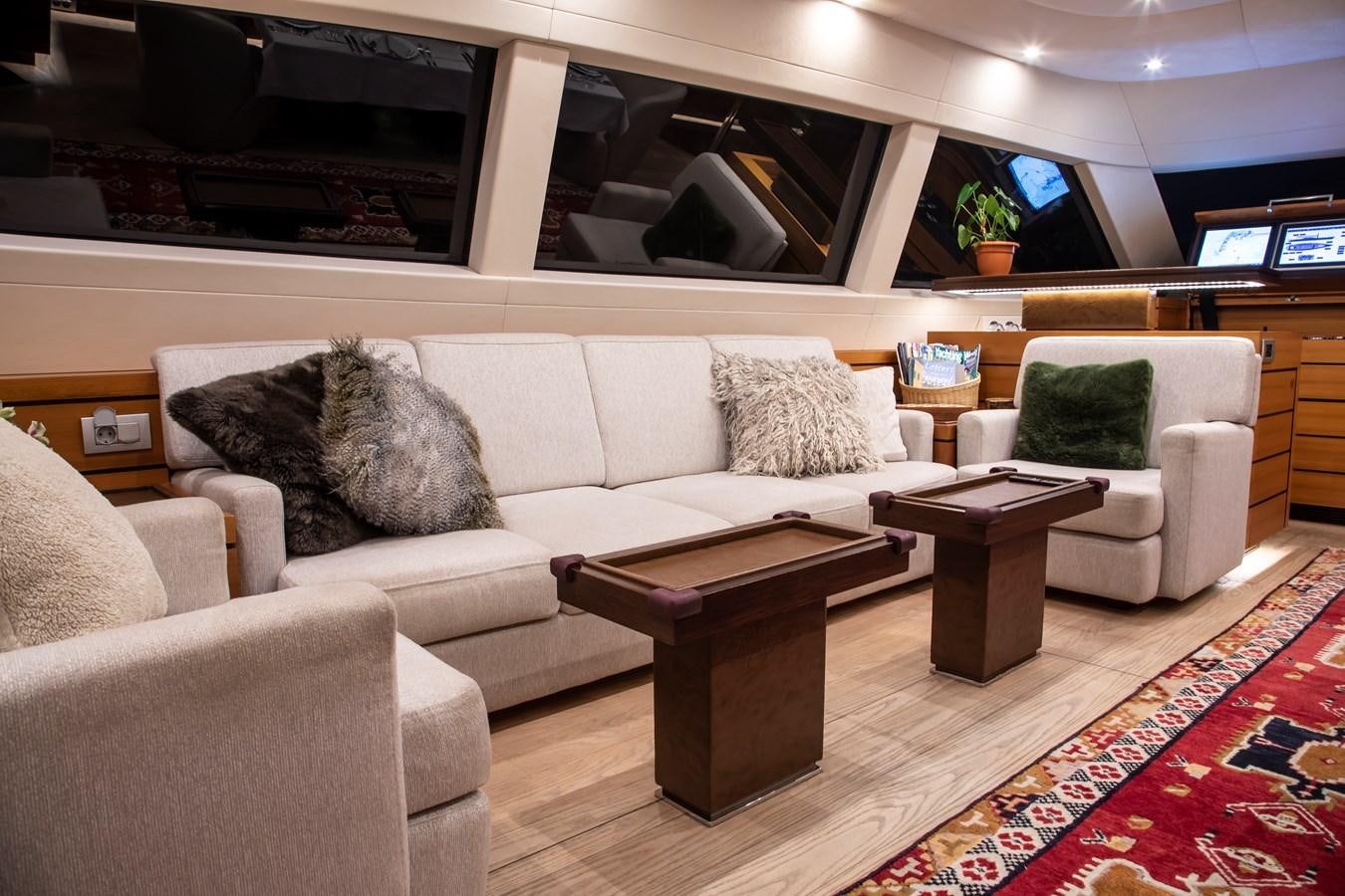 a living room with a couch and a coffee table aboard PATEA Yacht for Sale