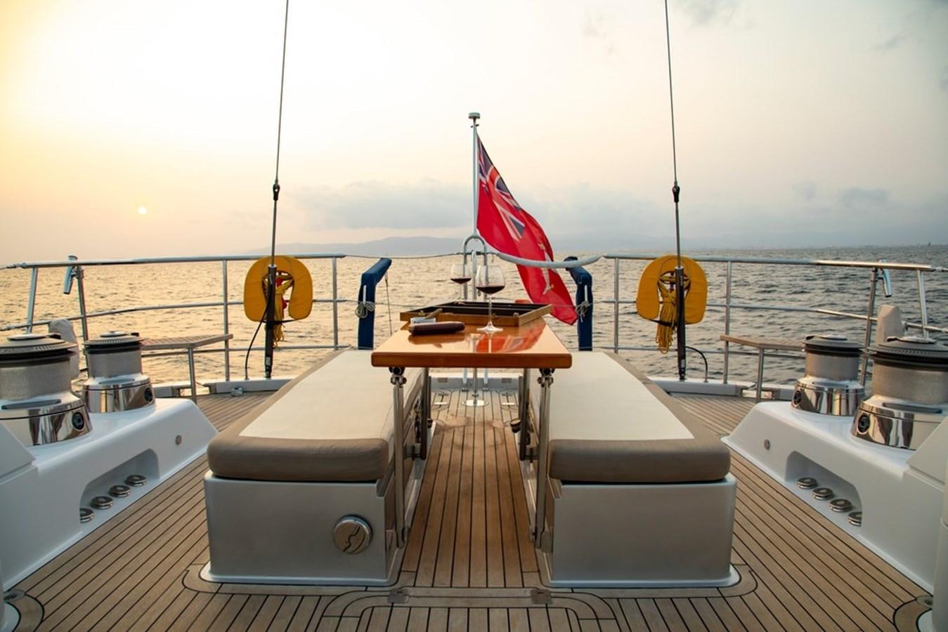 a boat with a flag on the deck aboard PATEA Yacht for Sale