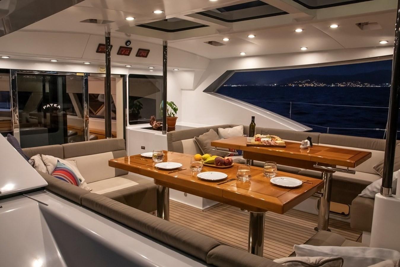 a room with a table and chairs aboard PATEA Yacht for Sale