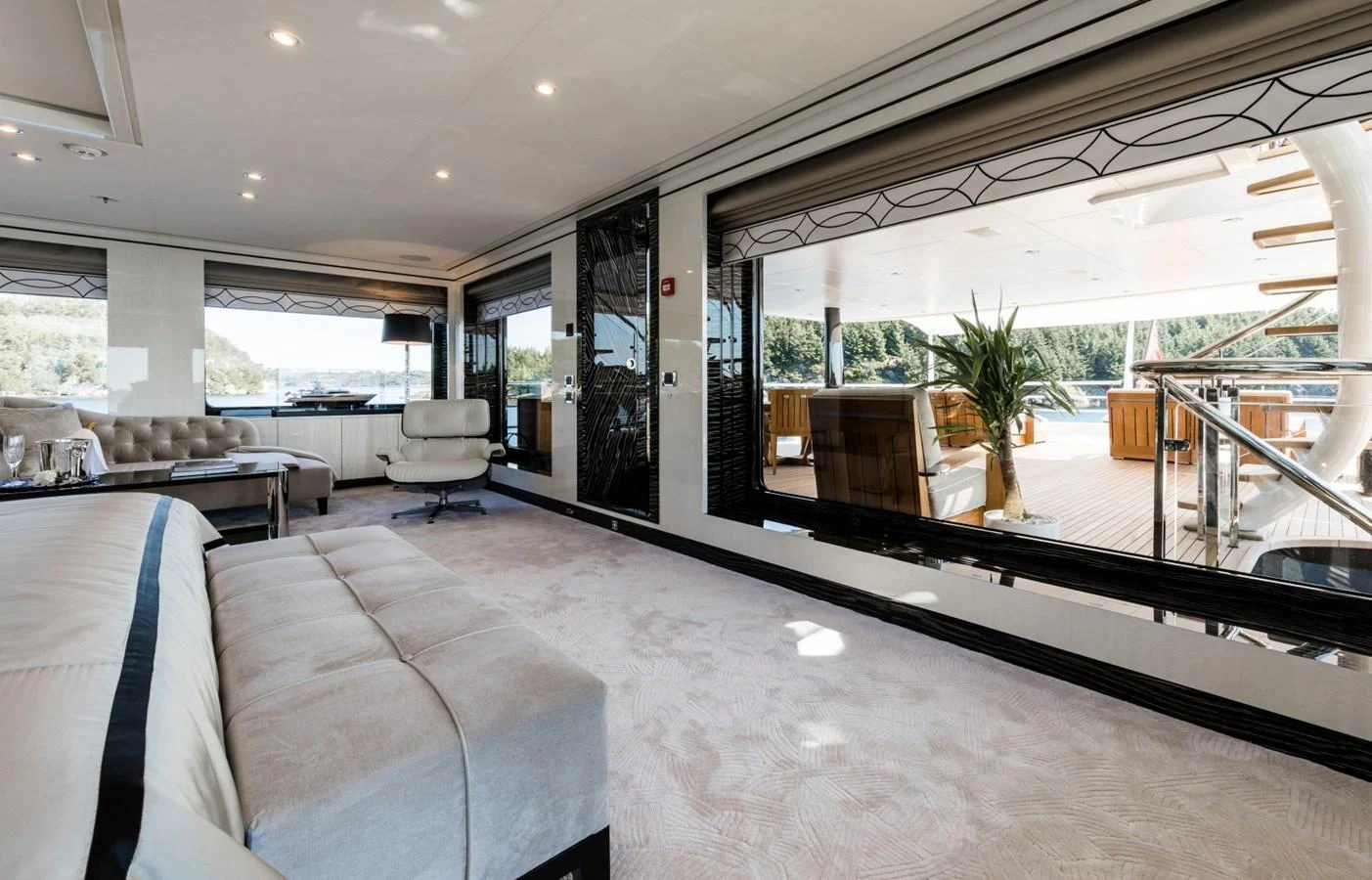 a large room with a large glass window and a couch aboard LILI Yacht for Sale