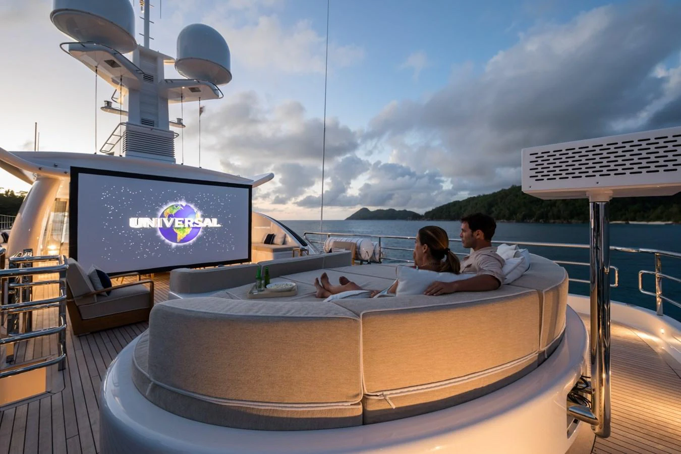 a couple of people sitting in a bed on a balcony aboard LILI Yacht for Sale