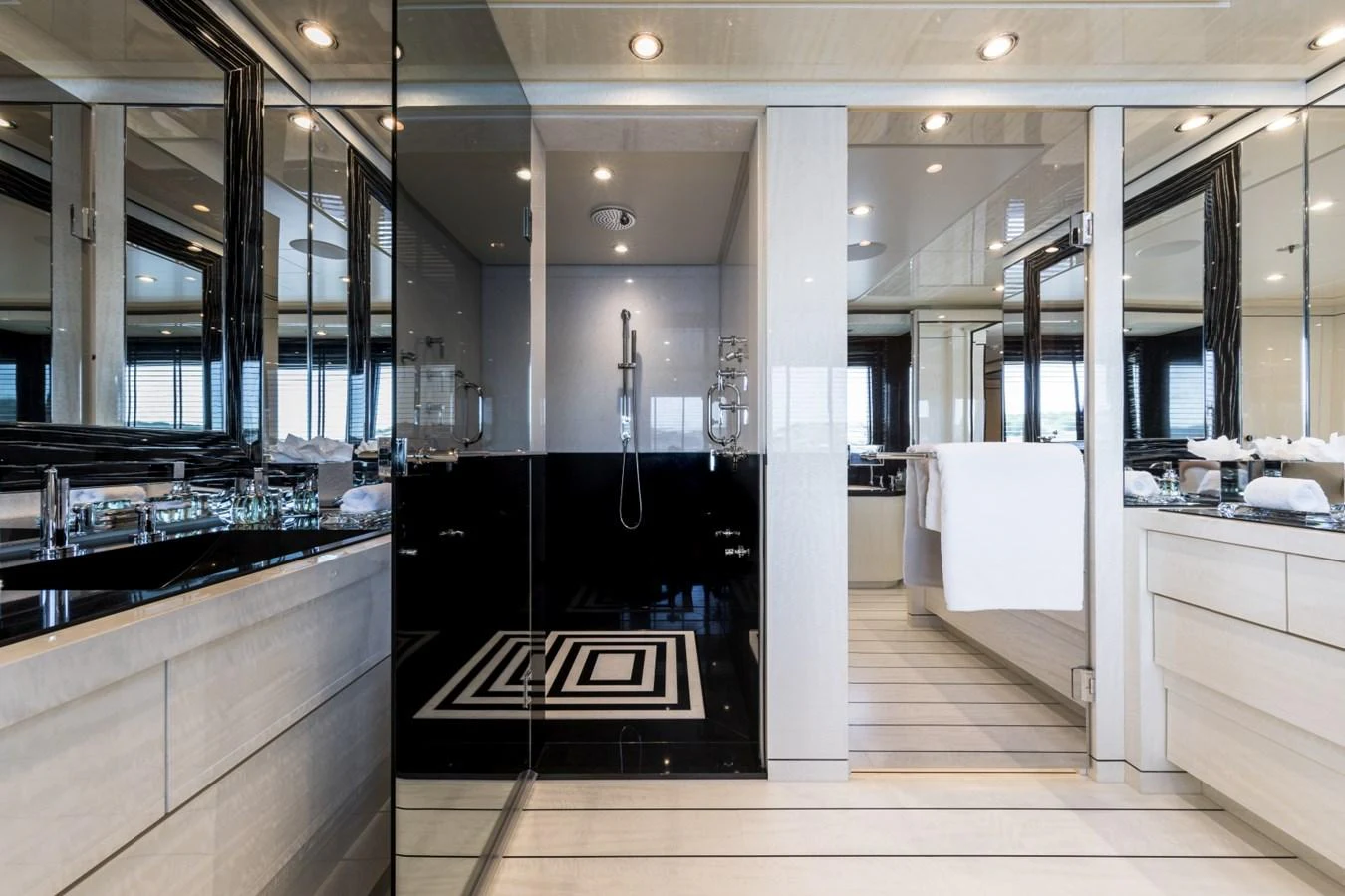 a large bathroom with a large glass shower aboard LILI Yacht for Sale