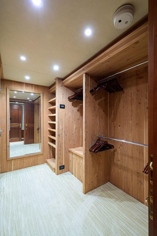 a wooden closet with a mirror aboard IMPETUOUS Yacht for Sale