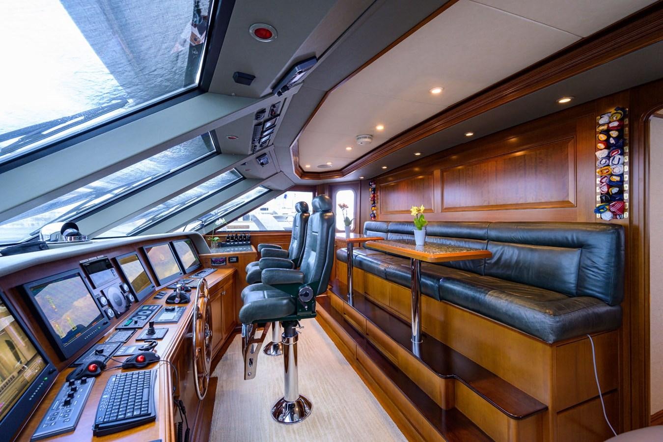 a room with a couch and a desk with computers aboard IMPETUOUS Yacht for Sale