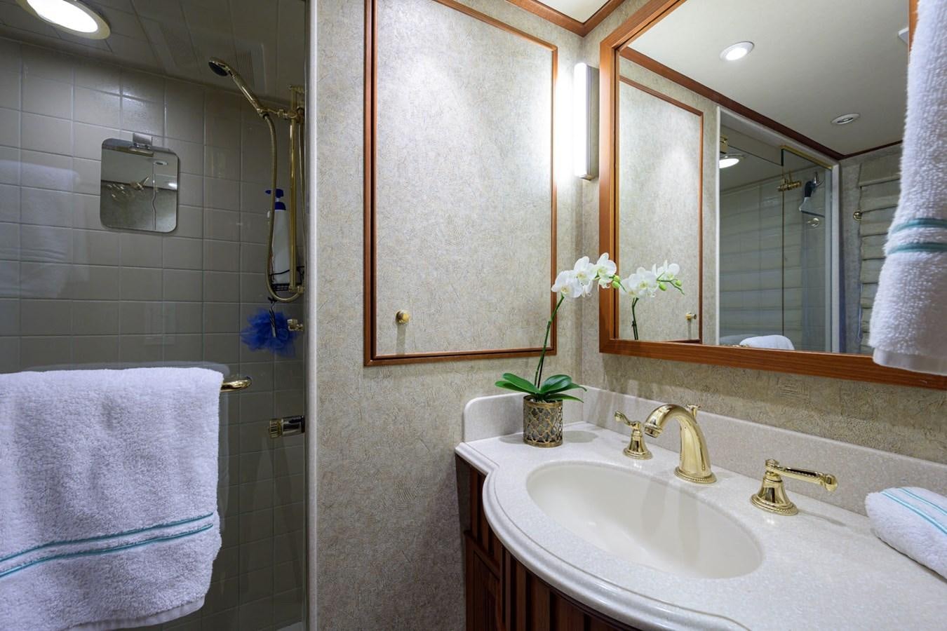 a bathroom with a sink and a mirror aboard IMPETUOUS Yacht for Sale