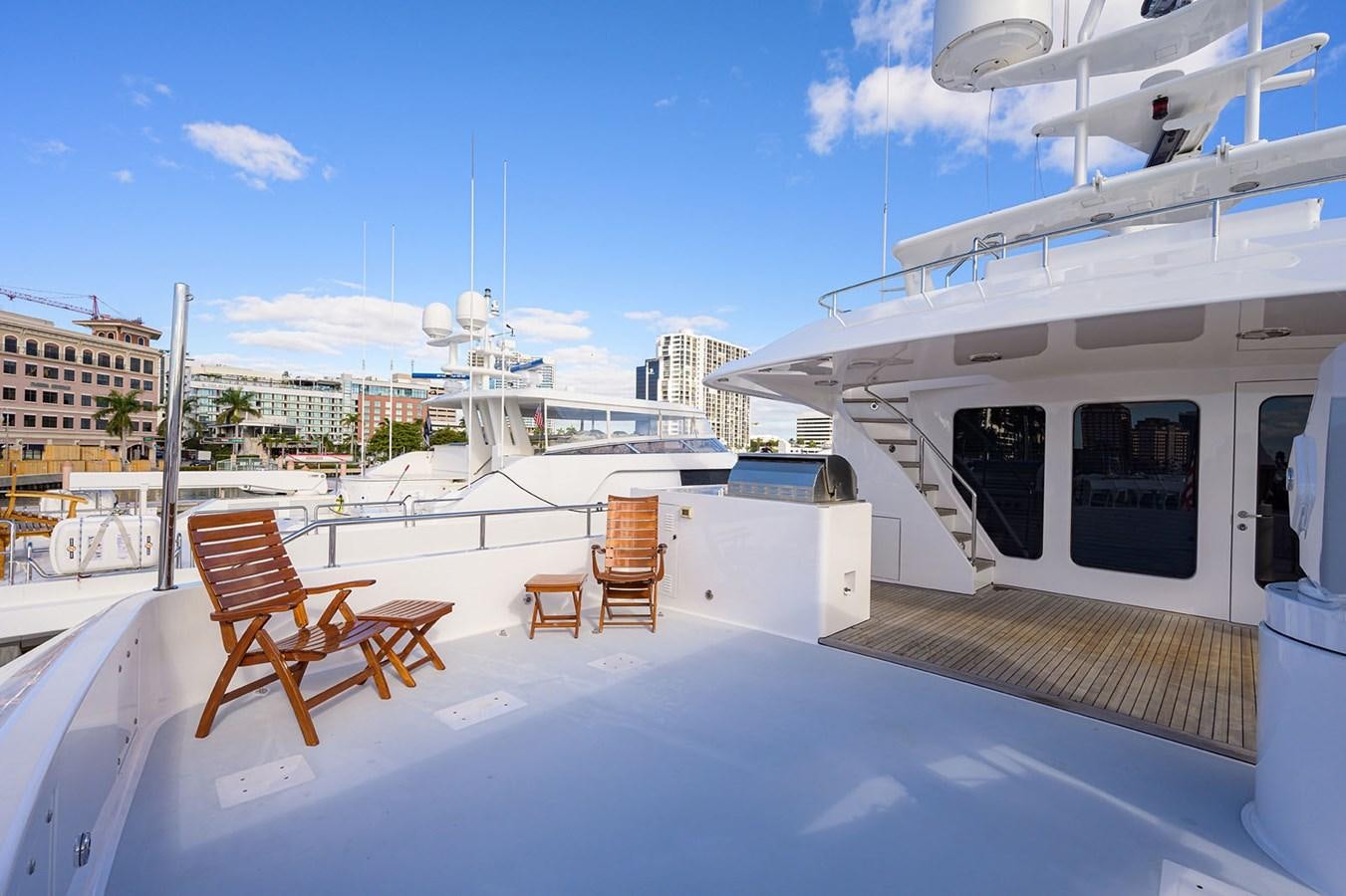 a deck with chairs and tables on it aboard IMPETUOUS Yacht for Sale