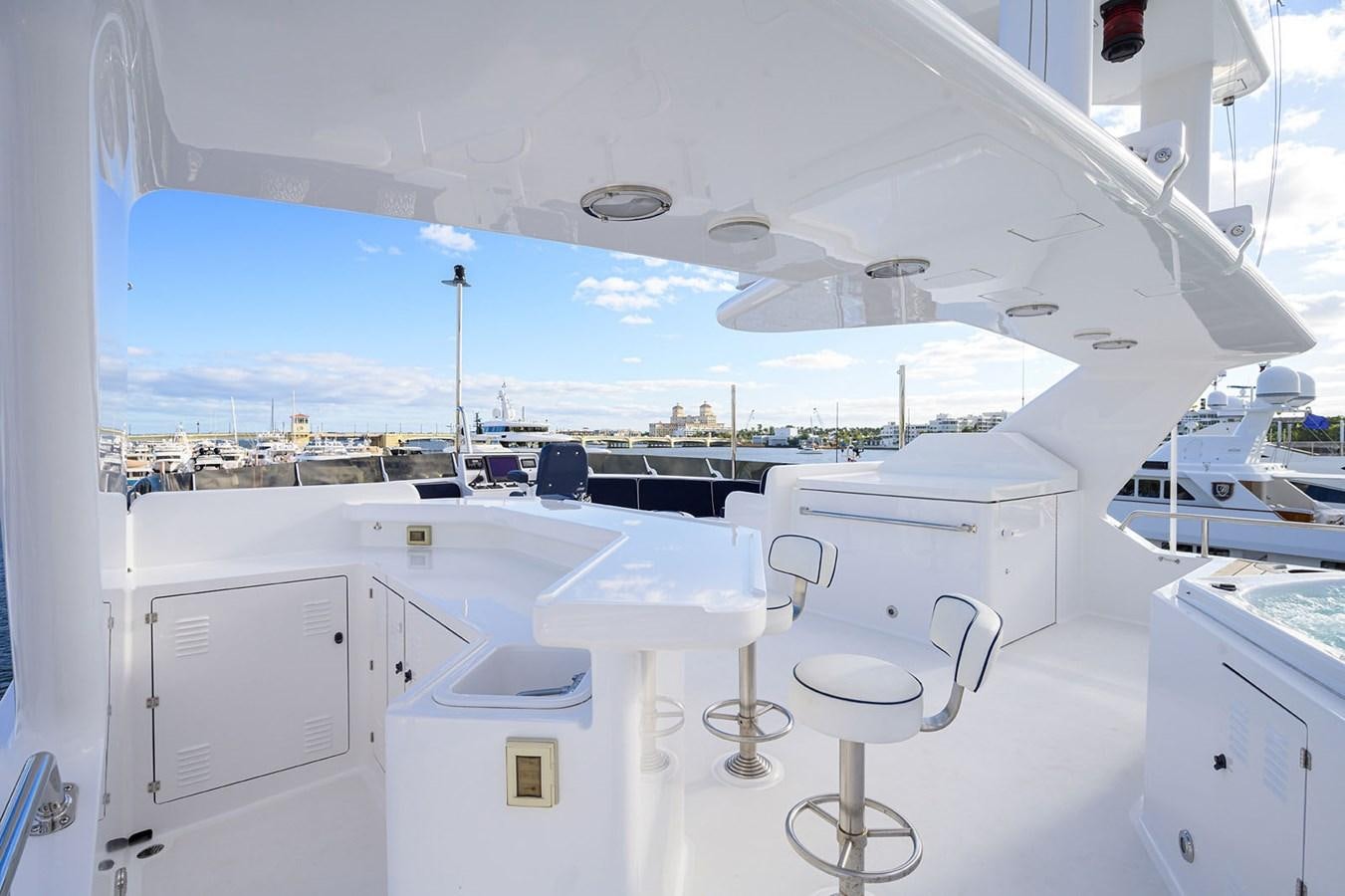 a room with white tables and chairs aboard IMPETUOUS Yacht for Sale