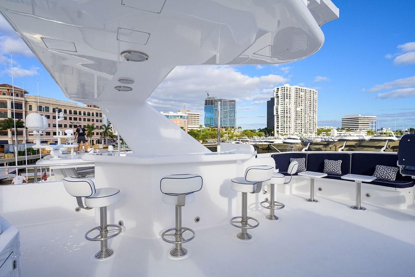 a large white building with a large white table and chairs and a large body of water aboard IMPETUOUS Yacht for Sale