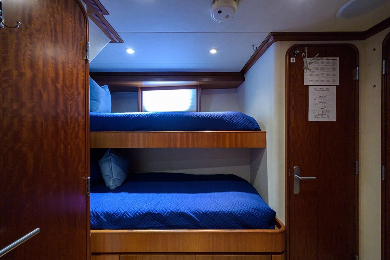 a room with a bed and a door aboard IMPETUOUS Yacht for Sale