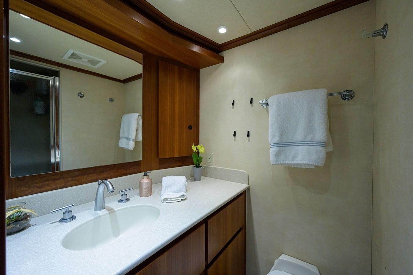 a bathroom with a large mirror aboard IMPETUOUS Yacht for Sale