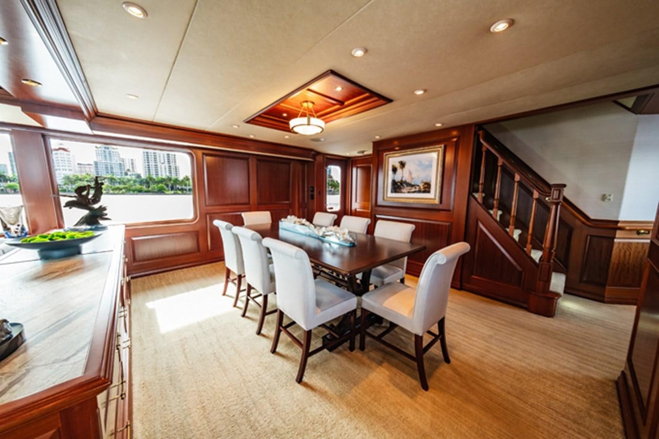 a large dining room with wood cabinets aboard IMPETUOUS Yacht for Sale