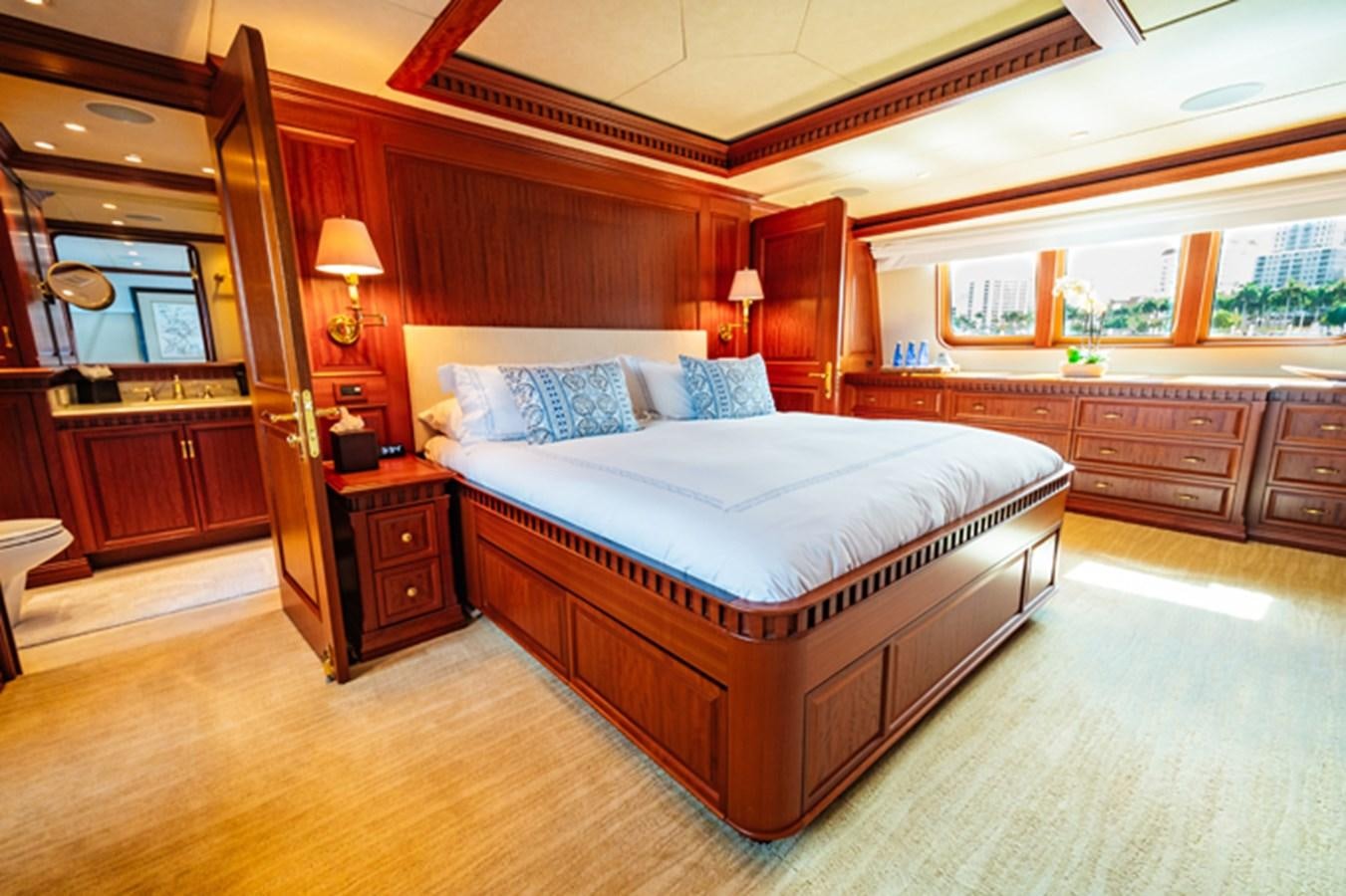 a bedroom with a large bed aboard IMPETUOUS Yacht for Sale