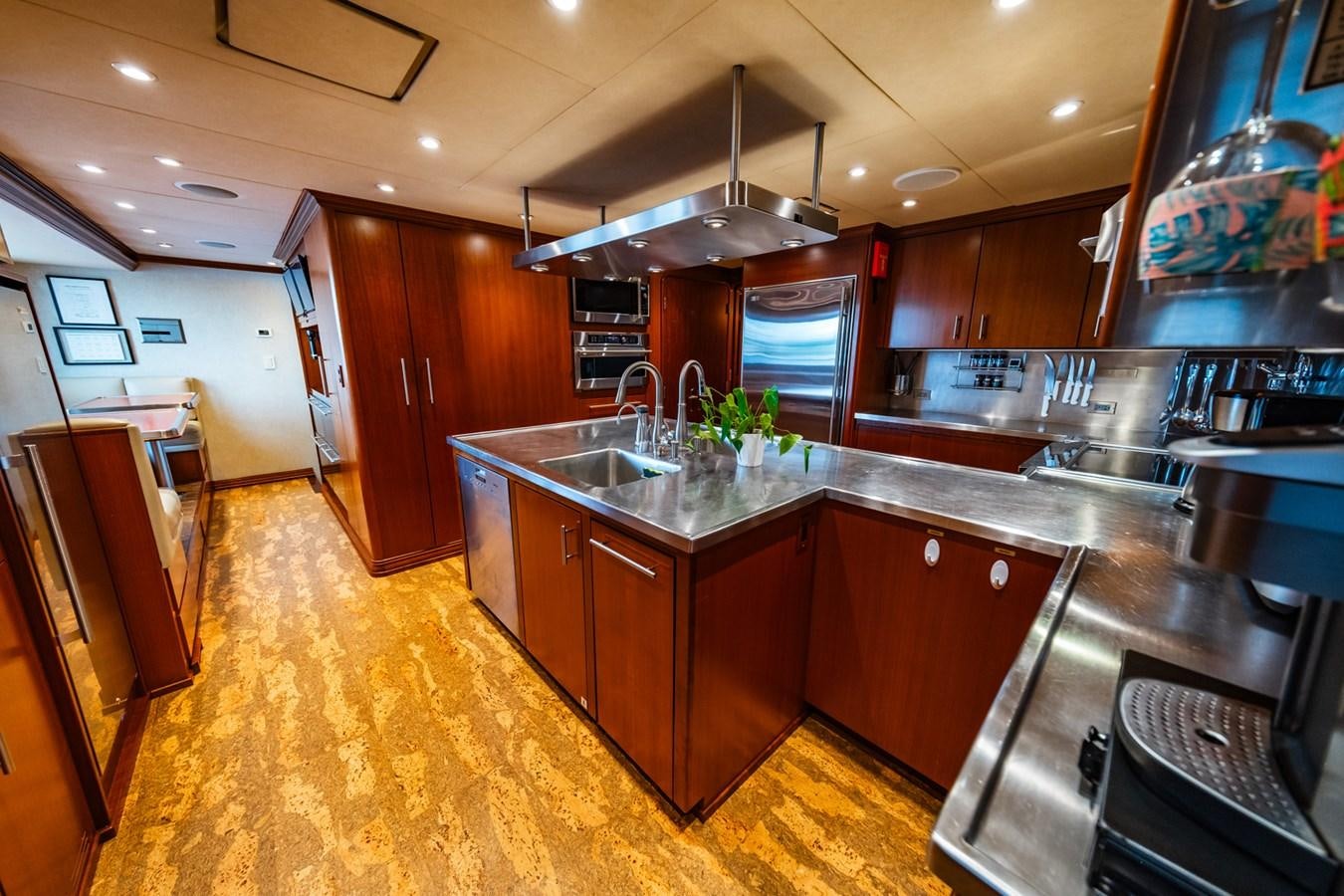 a kitchen with wooden cabinets aboard IMPETUOUS Yacht for Sale