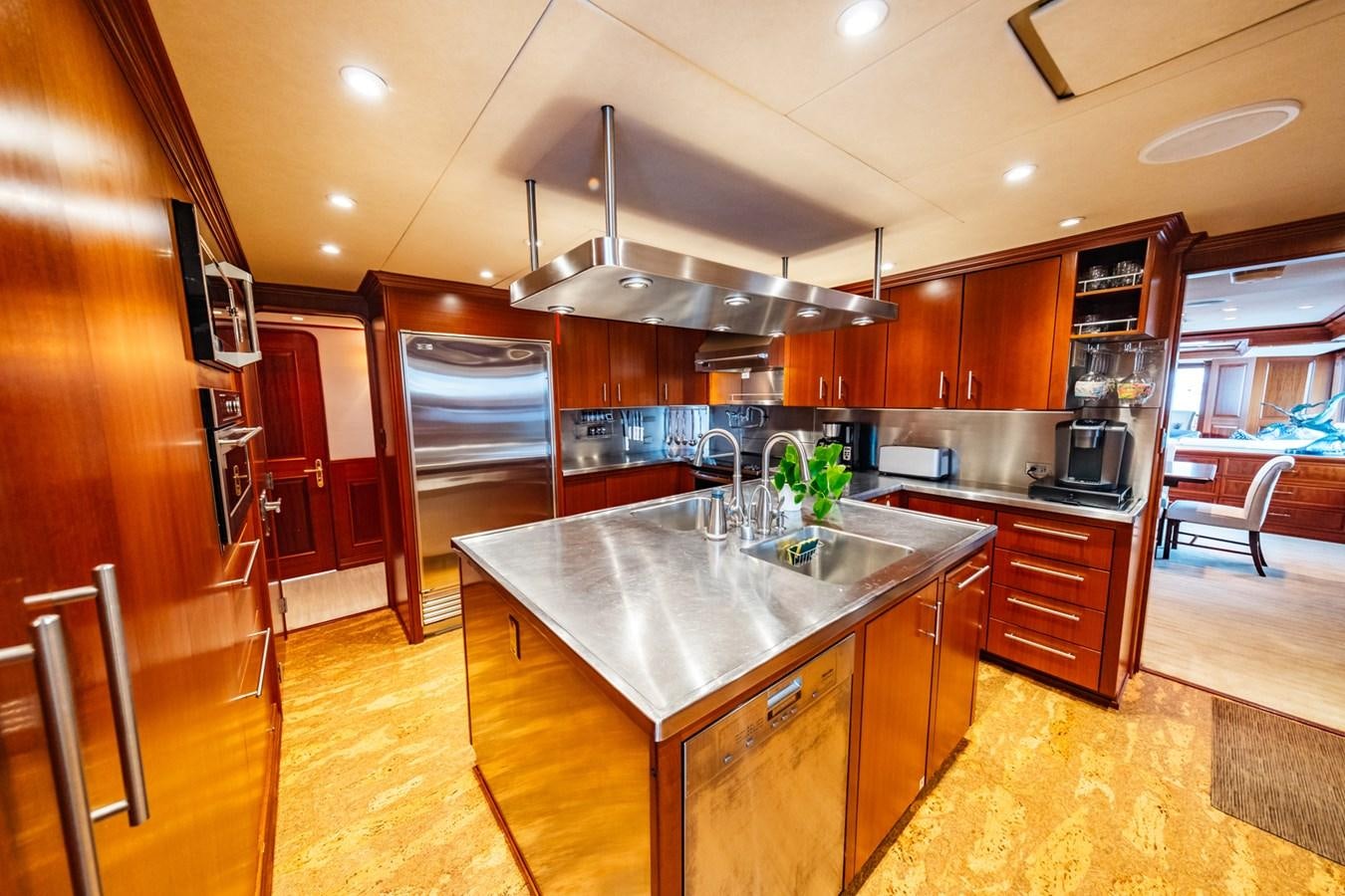 a kitchen with a stainless steel island aboard IMPETUOUS Yacht for Sale