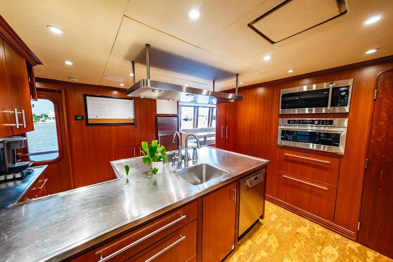 a kitchen with wooden cabinets aboard IMPETUOUS Yacht for Sale