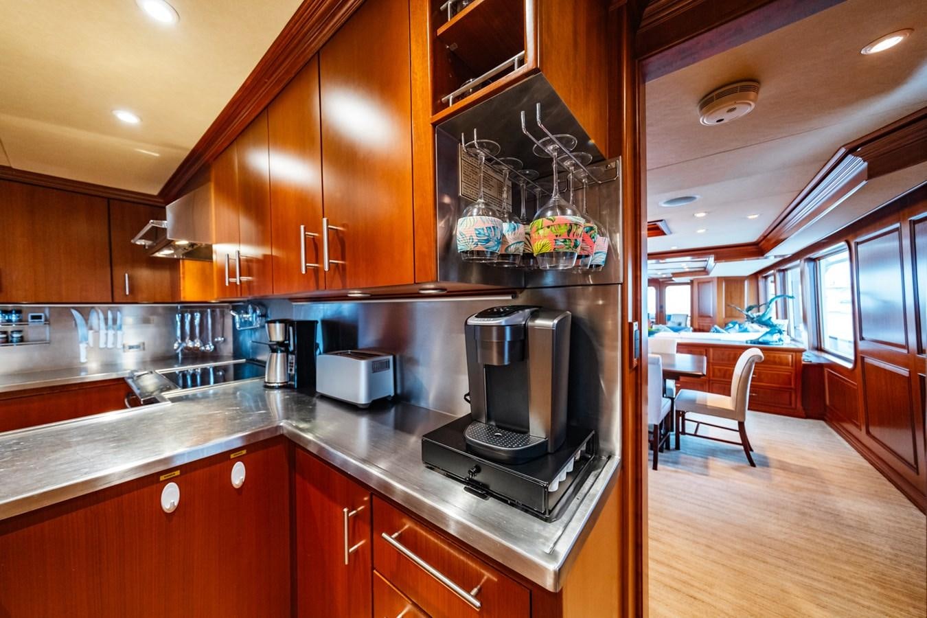 a kitchen with wooden cabinets aboard IMPETUOUS Yacht for Sale