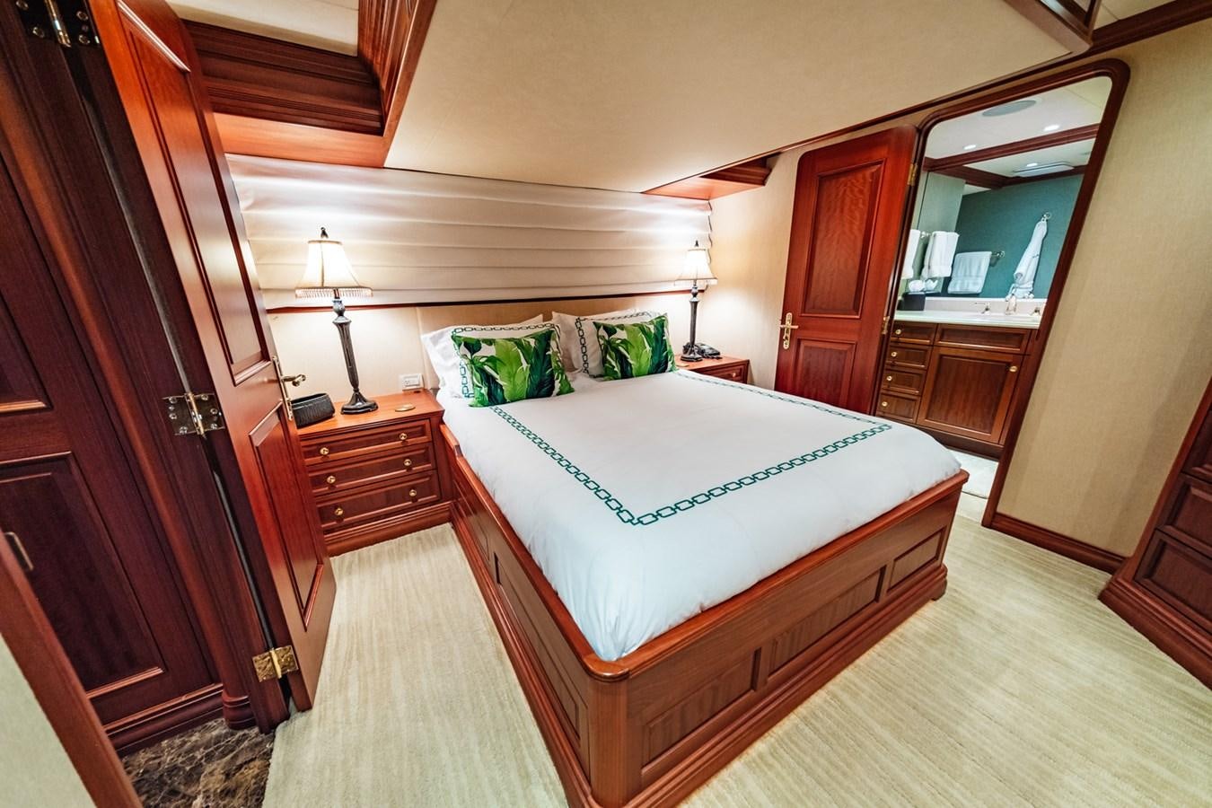 a bedroom with a bed and a desk aboard IMPETUOUS Yacht for Sale