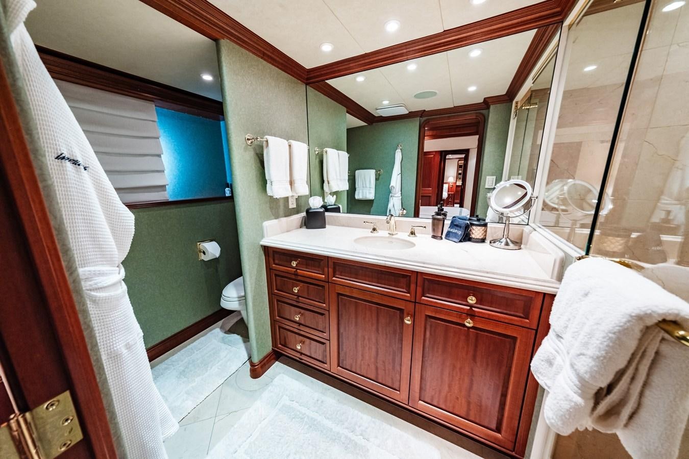 a bathroom with a sink and a mirror aboard IMPETUOUS Yacht for Sale
