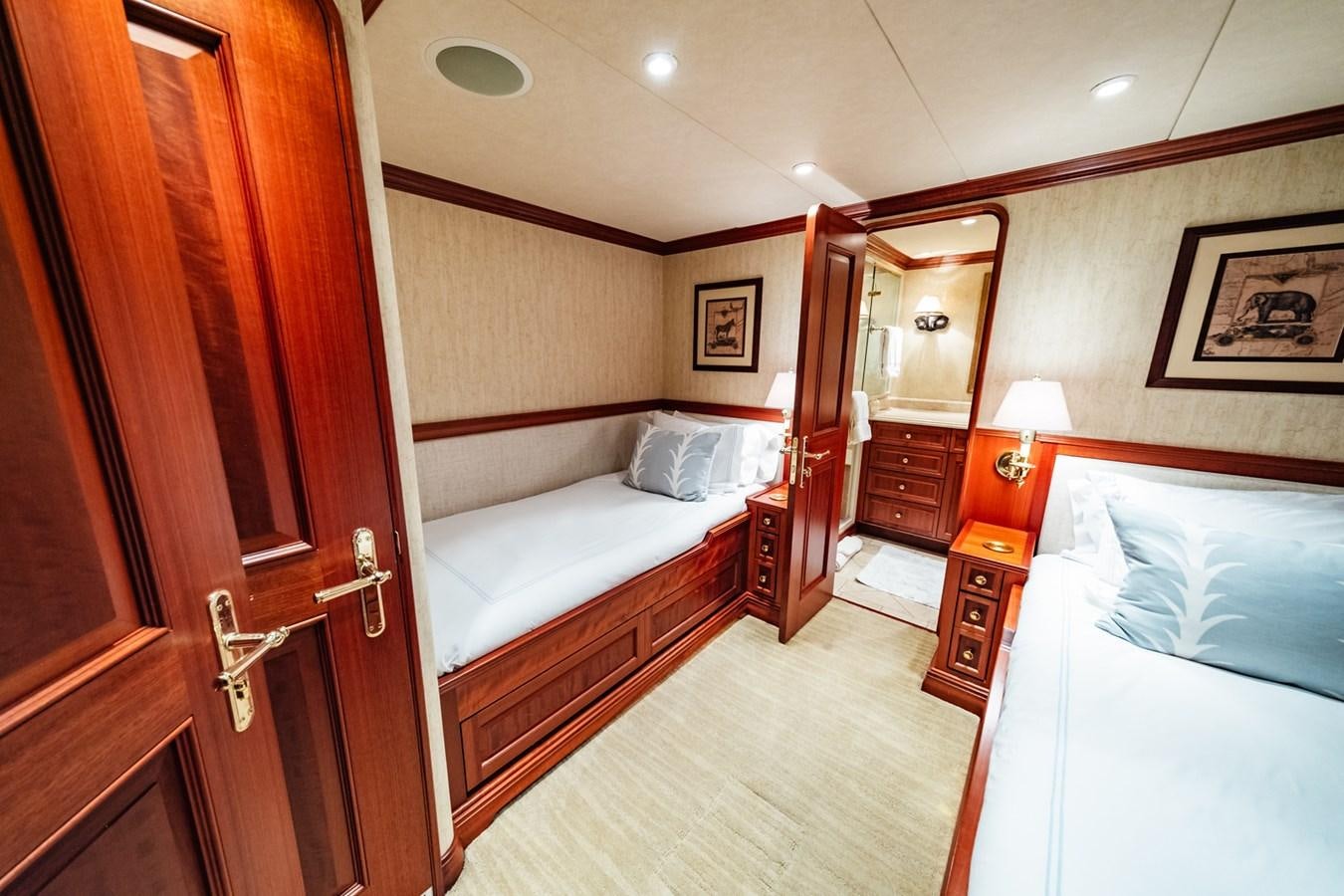 a room with a bed and a mirror aboard IMPETUOUS Yacht for Sale