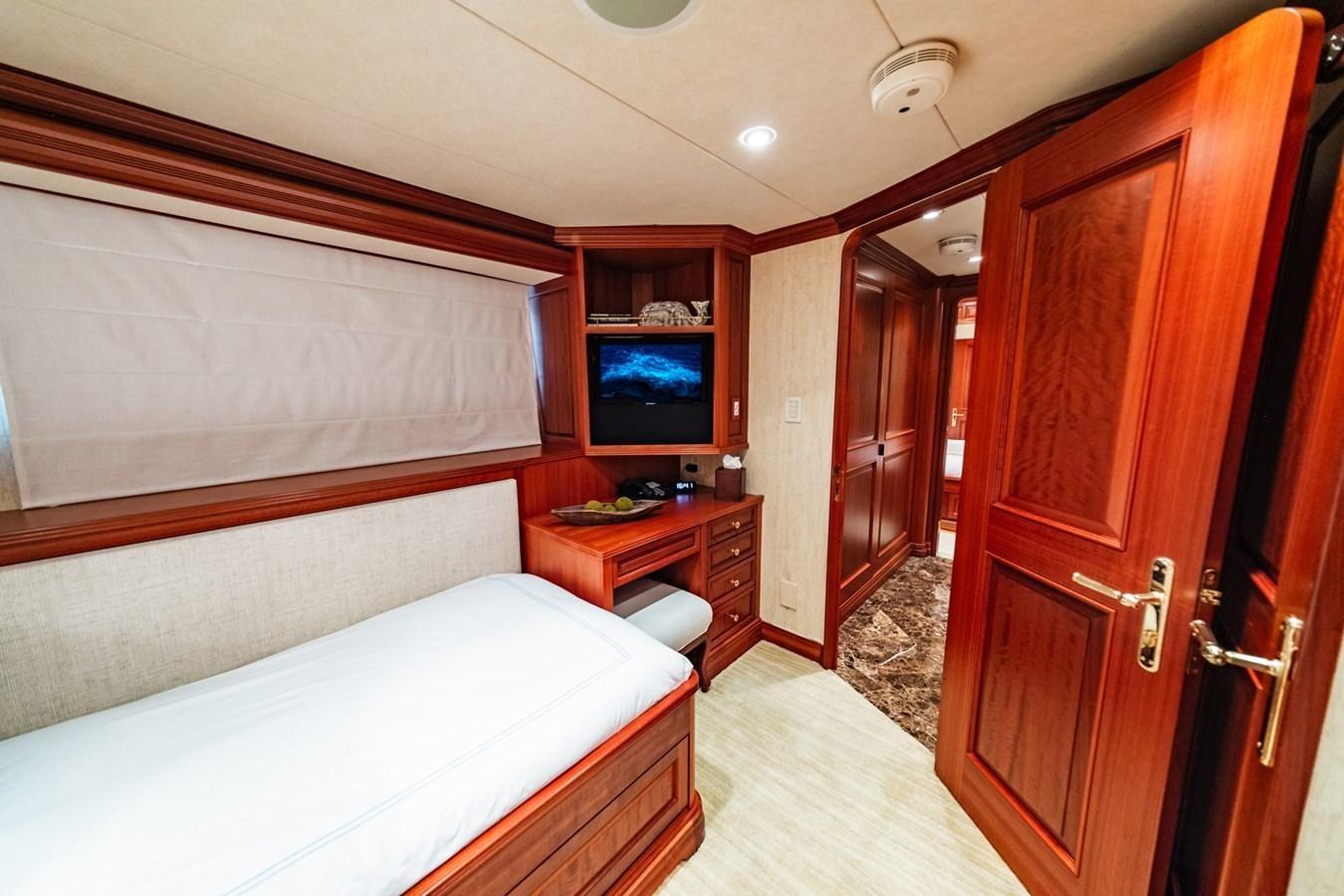 a room with a bed and a television aboard IMPETUOUS Yacht for Sale