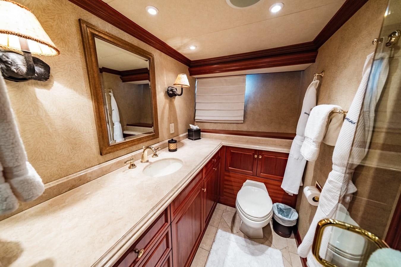 a bathroom with a large bathtub and toilet aboard IMPETUOUS Yacht for Sale