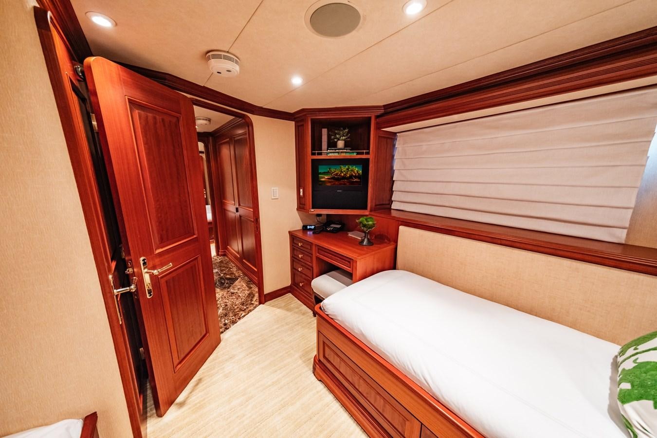 a bedroom with a bed and a tv aboard IMPETUOUS Yacht for Sale