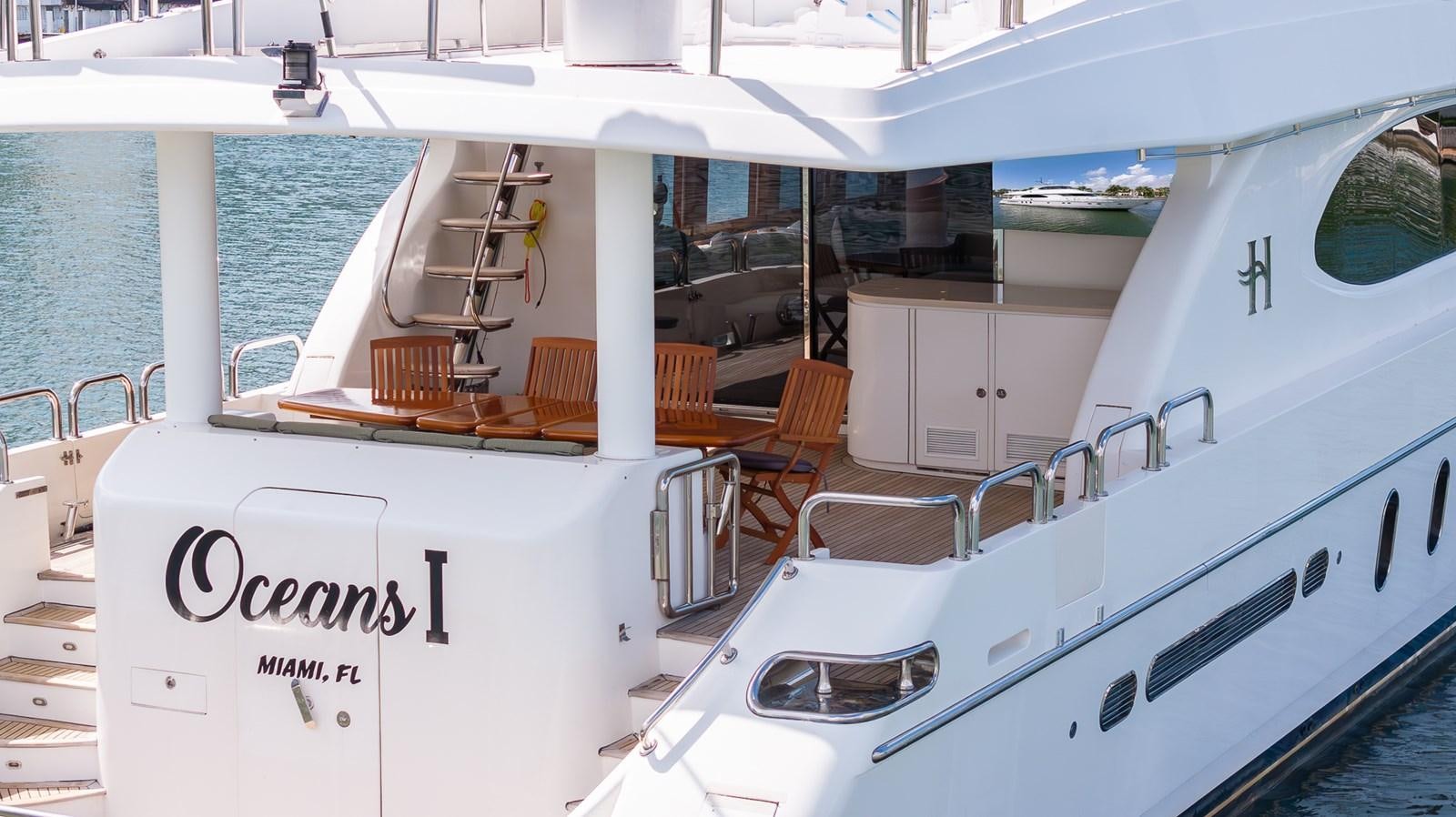 a boat with a table and chairs on the deck aboard OCEAN 1 Yacht for Sale