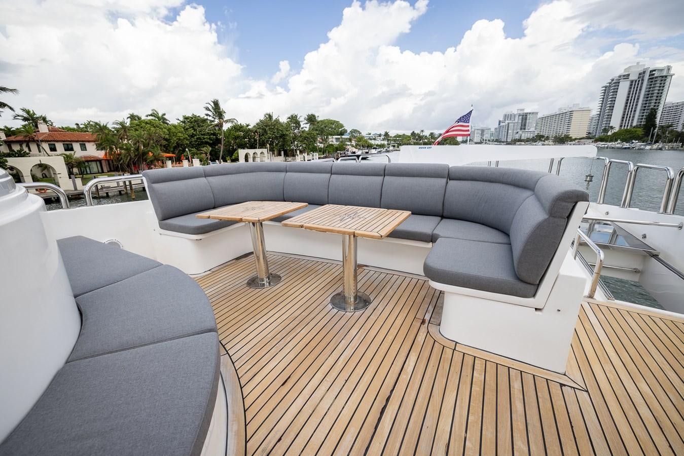 a deck with a table and chairs aboard OCEAN 1 Yacht for Sale