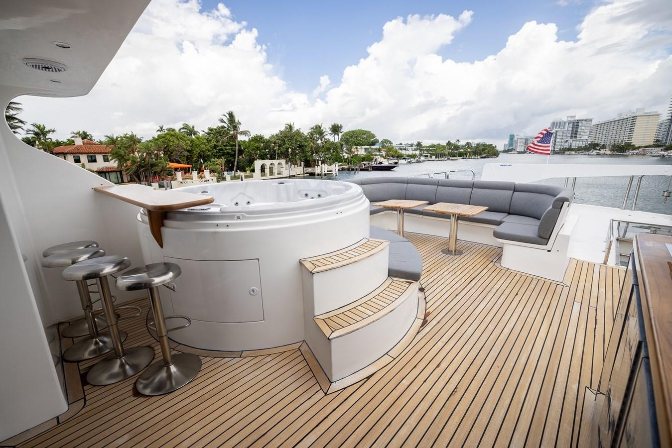 a large white bathtub on a deck with chairs and tables aboard OCEAN 1 Yacht for Sale