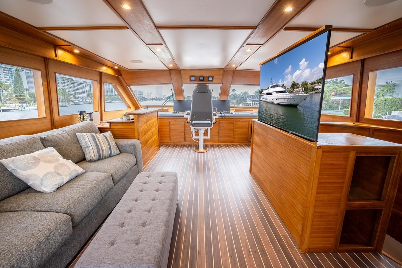 a living room with a large tv aboard OCEAN 1 Yacht for Sale