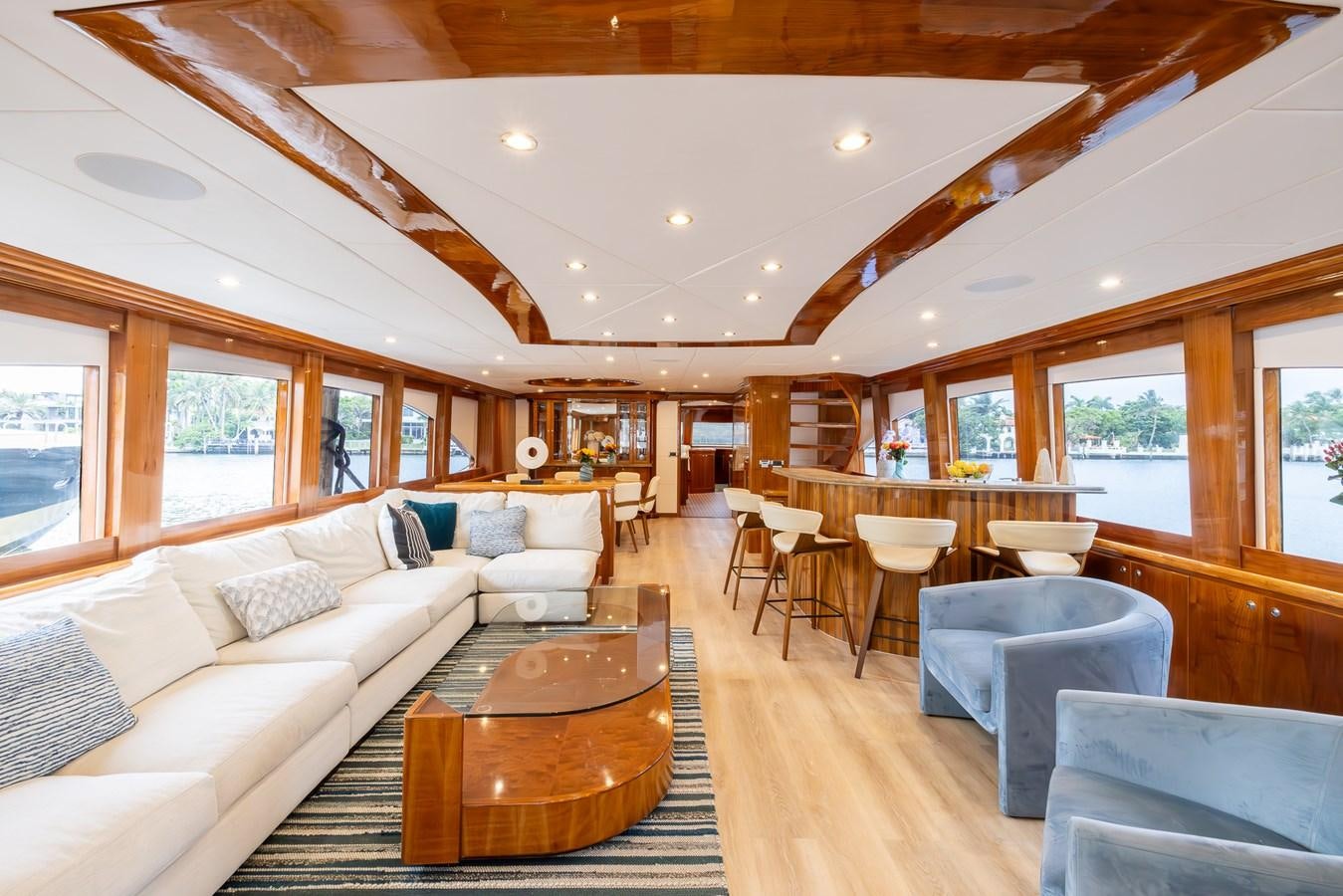 a living room with a large wood table and chairs aboard OCEAN 1 Yacht for Sale