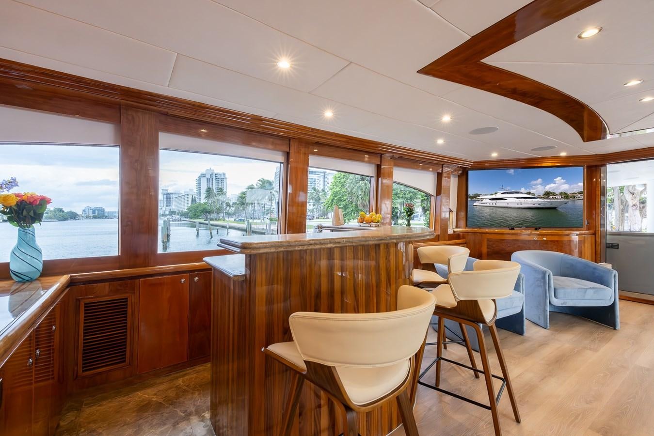 a room with a wood floor and a wood table and chairs aboard OCEAN 1 Yacht for Sale