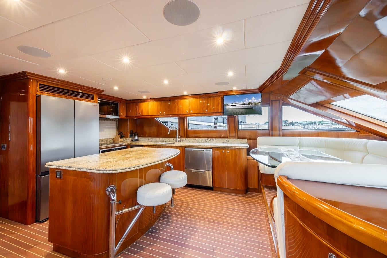 a large kitchen with a bar and fridge aboard OCEAN 1 Yacht for Sale