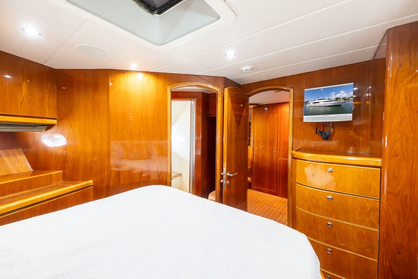 a room with a bed and a dresser aboard OCEAN 1 Yacht for Sale