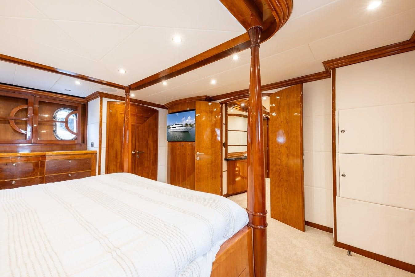 a bedroom with a bed and a wood door aboard OCEAN 1 Yacht for Sale