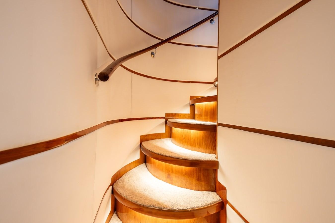 a wooden staircase with a wood railing aboard OCEAN 1 Yacht for Sale
