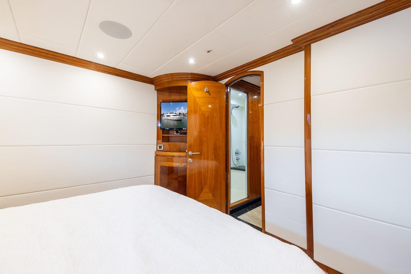 a bedroom with a bed and a closet aboard OCEAN 1 Yacht for Sale