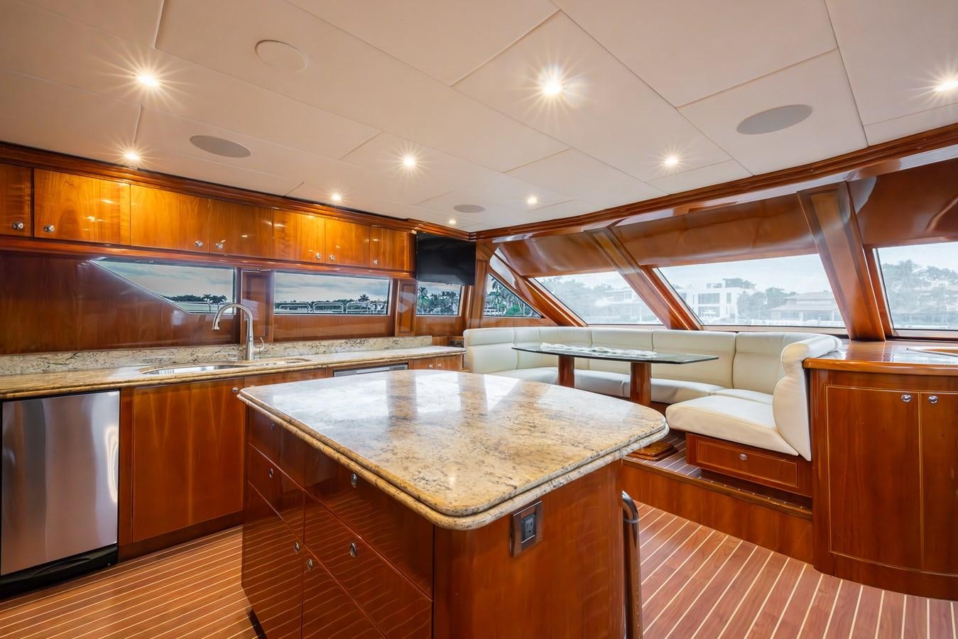 a kitchen with a bar and a table aboard OCEAN 1 Yacht for Sale