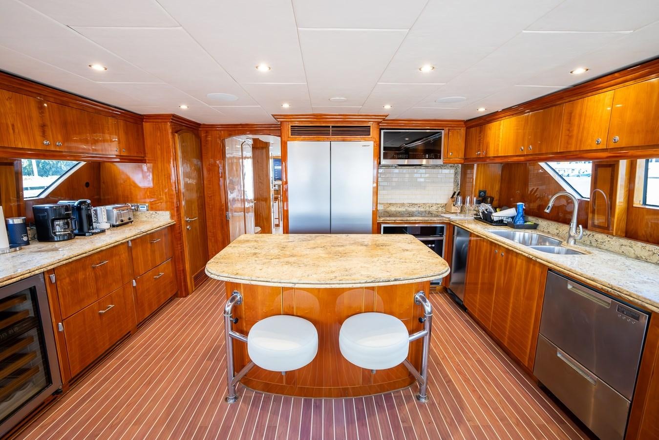 a kitchen with wooden cabinets aboard OCEAN 1 Yacht for Sale