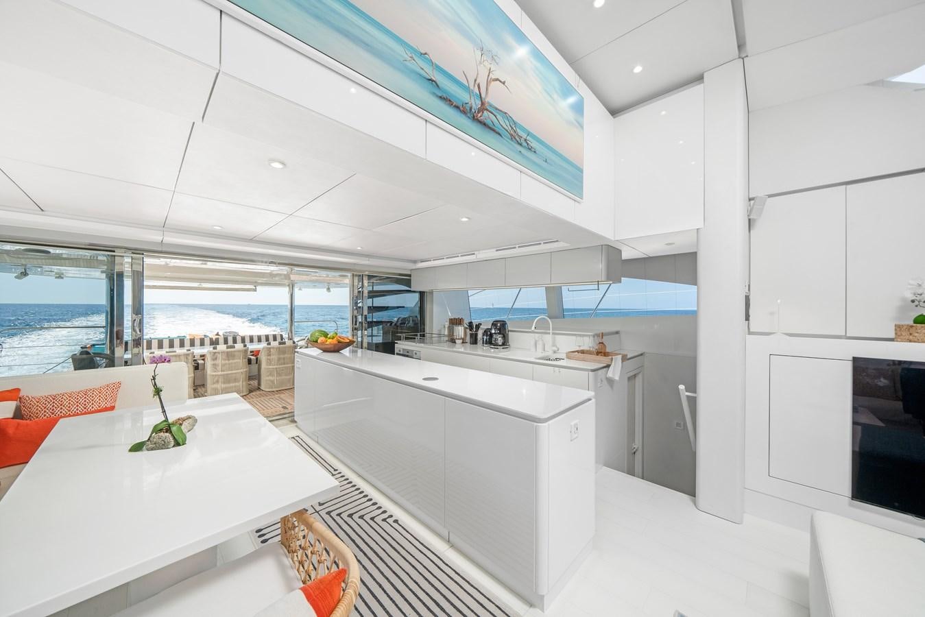 a modern kitchen with white cabinets aboard ROYAL RITA Yacht for Sale