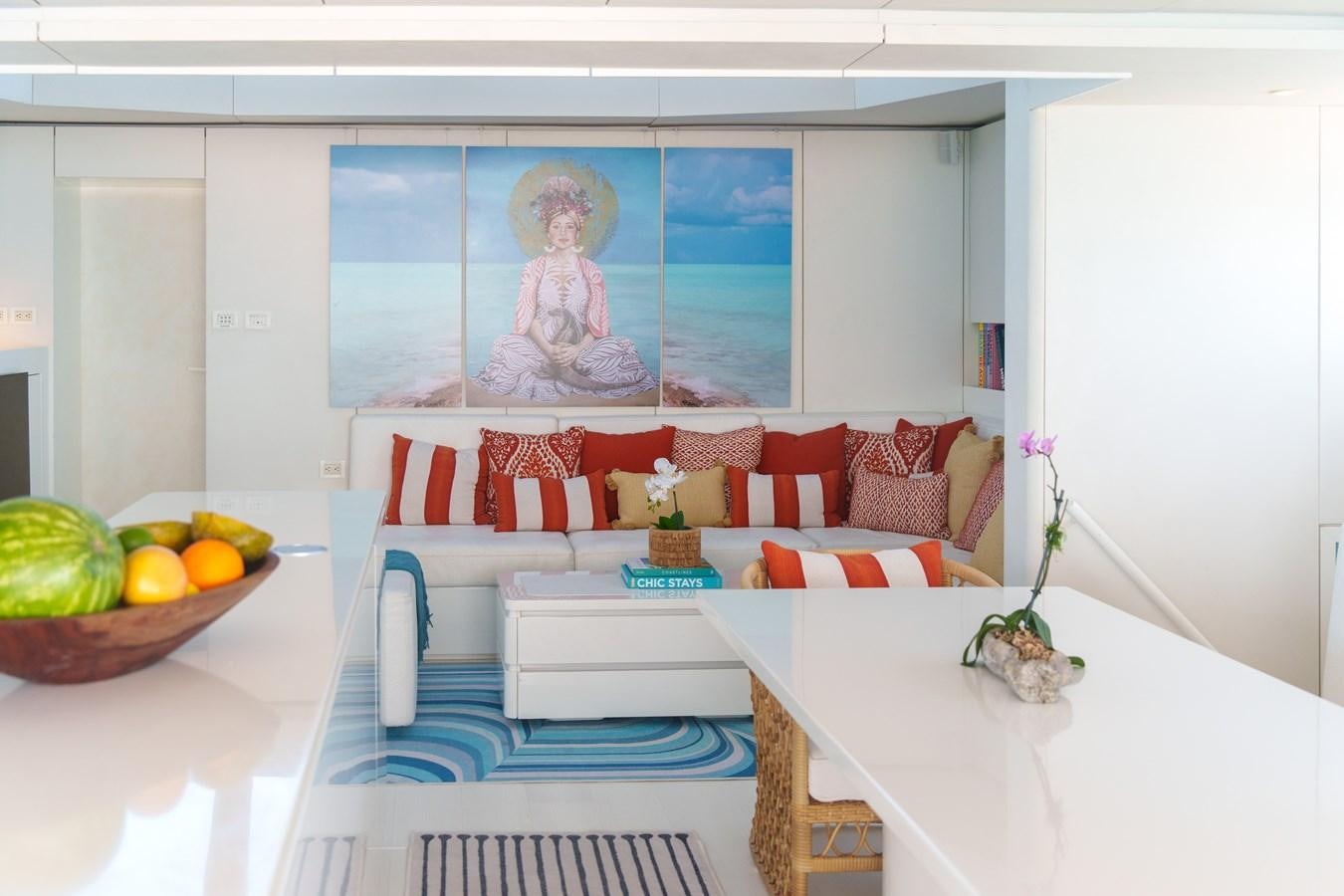 a living room with a white table and a white table with a painting aboard ROYAL RITA Yacht for Sale