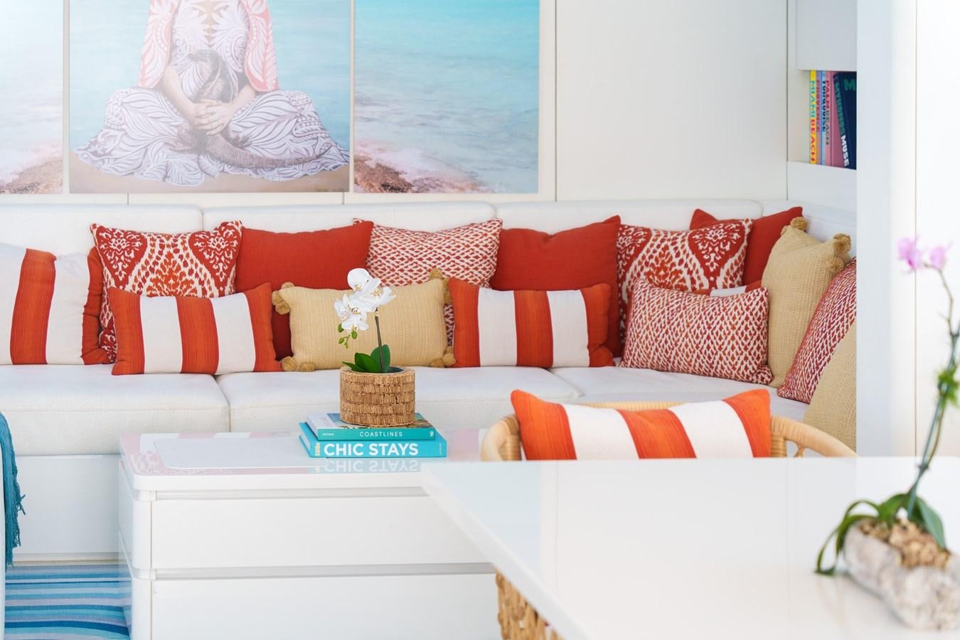 a white couch with pillows and a white tablecloth with a white tablecloth with a white cloth aboard ROYAL RITA Yacht for Sale