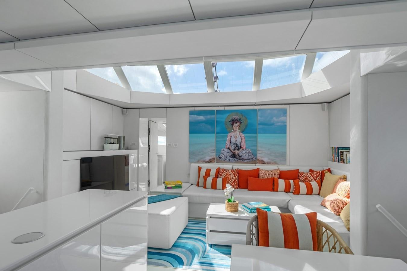 a living room with a white couch and a tv aboard ROYAL RITA Yacht for Sale