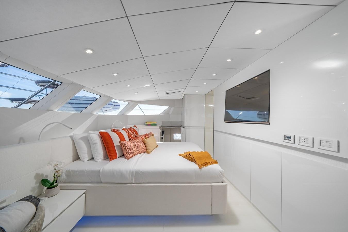 a white room with a white couch and a television aboard ROYAL RITA Yacht for Sale