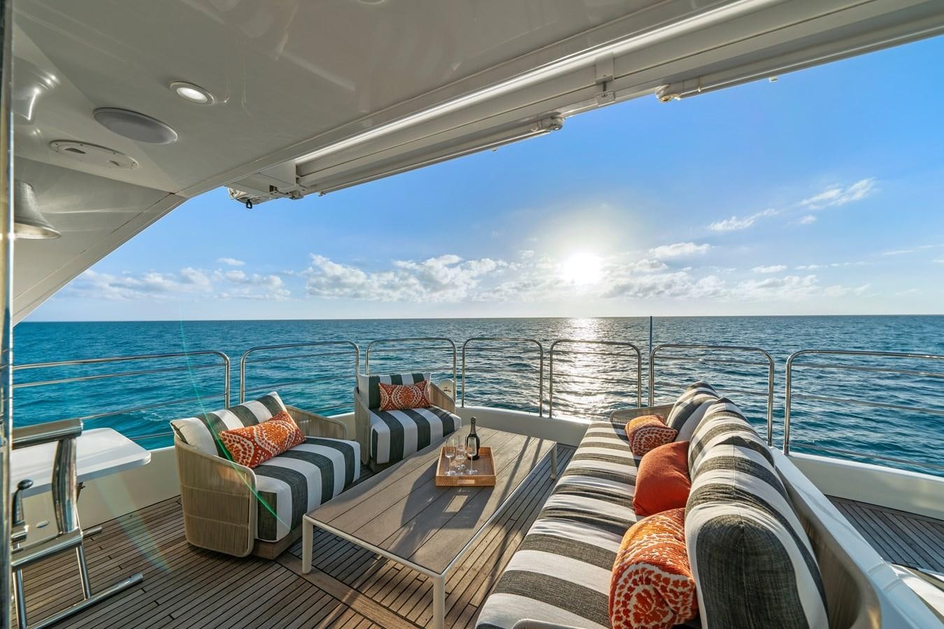 a balcony with a view of the ocean and the sun aboard ROYAL RITA Yacht for Sale