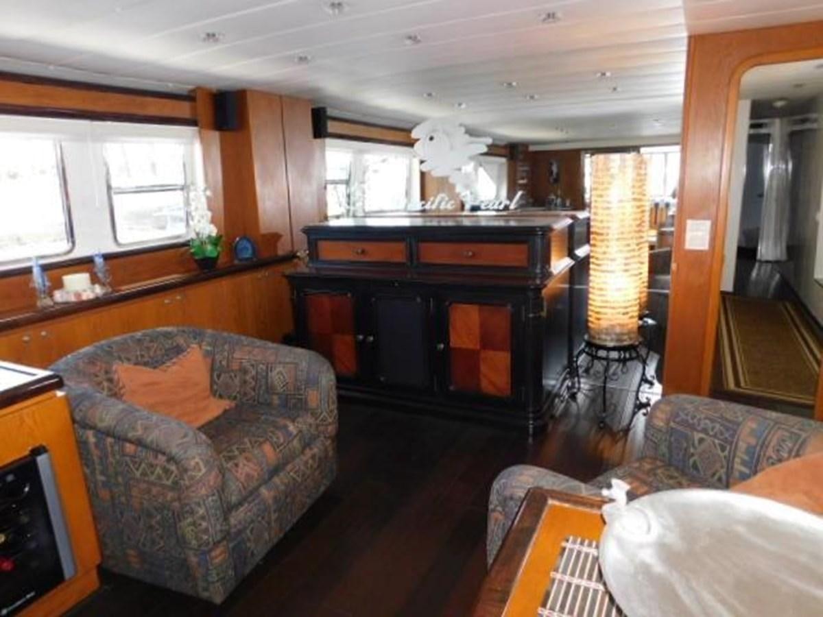 a living room with a piano aboard PACIFIC PEARL Yacht for Sale