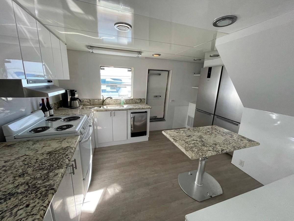 a kitchen with a marble counter top aboard PACIFIC PEARL Yacht for Sale