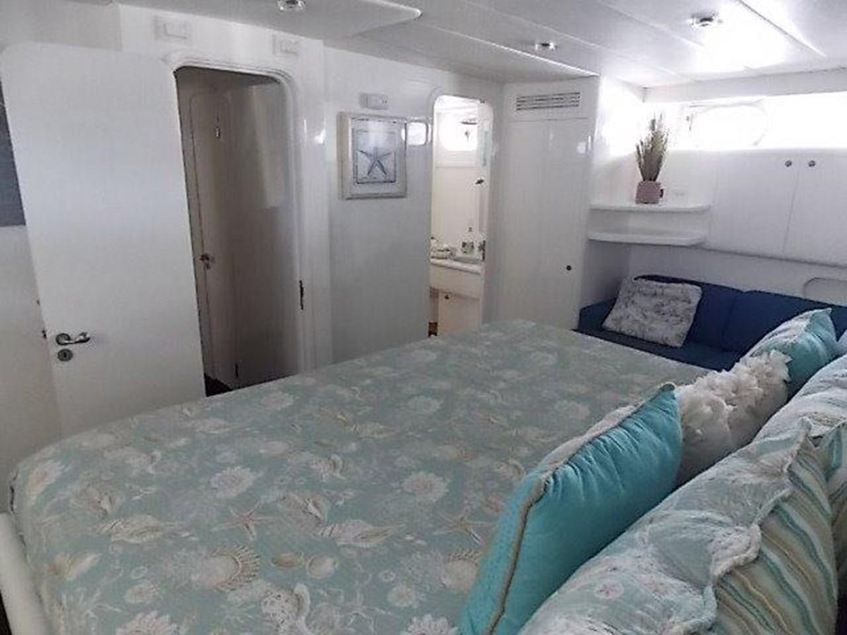 a bed in a room aboard PACIFIC PEARL Yacht for Sale