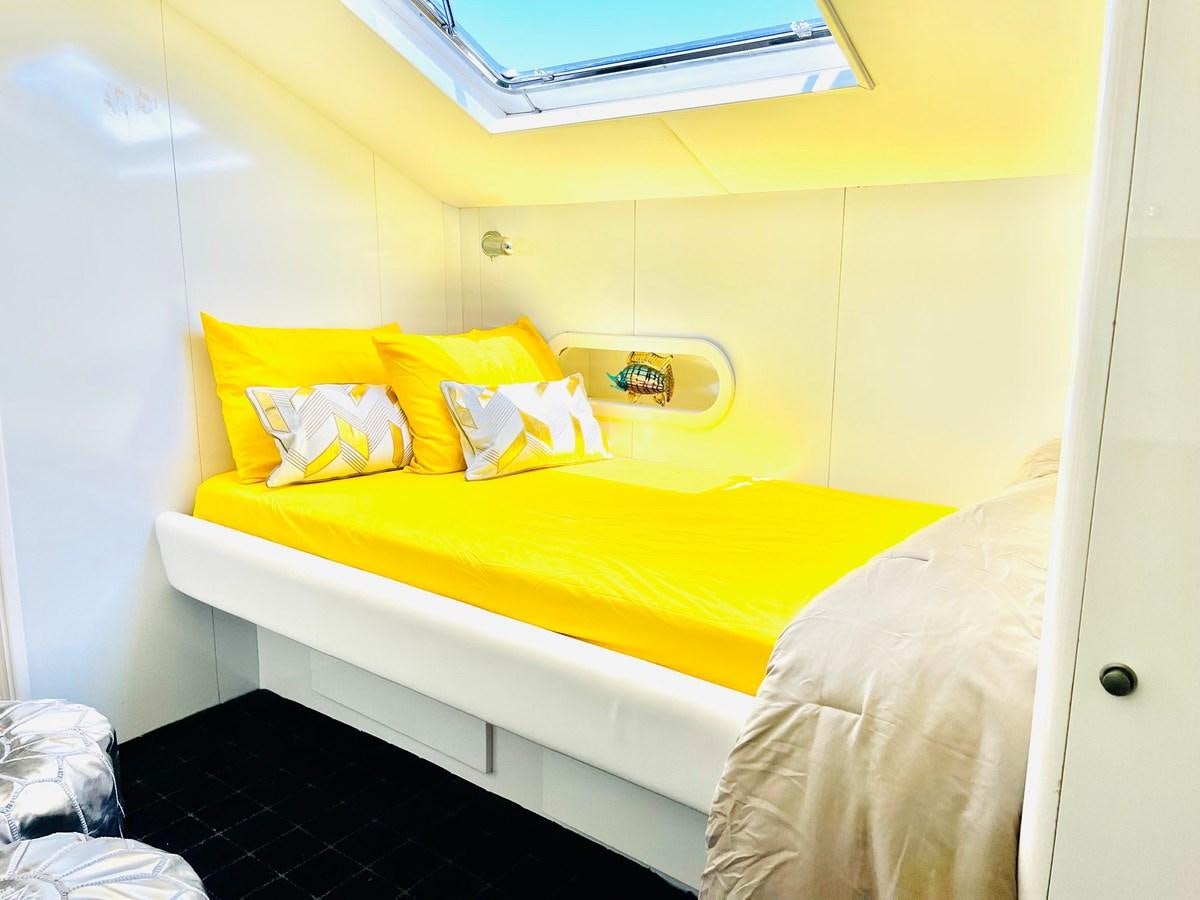 a small bed in a room aboard PACIFIC PEARL Yacht for Sale